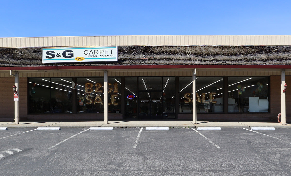Storefront of the S&G Carpet and More showroom in Cupertino with Best Sale window signs
