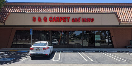 Storefront of the S&G Carpet and More showroom in Dublin, California, with red signage and a tile roof