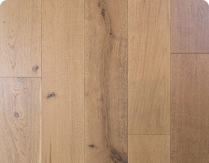 Wire-brushed tan oak hardwood flooring with knots, mineral streaks, and wide planks.