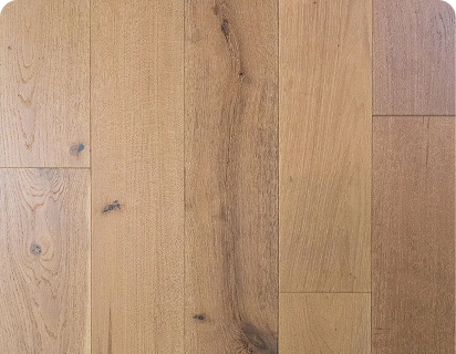 Wire-brushed tan oak hardwood flooring with knots, mineral streaks, and wide planks.