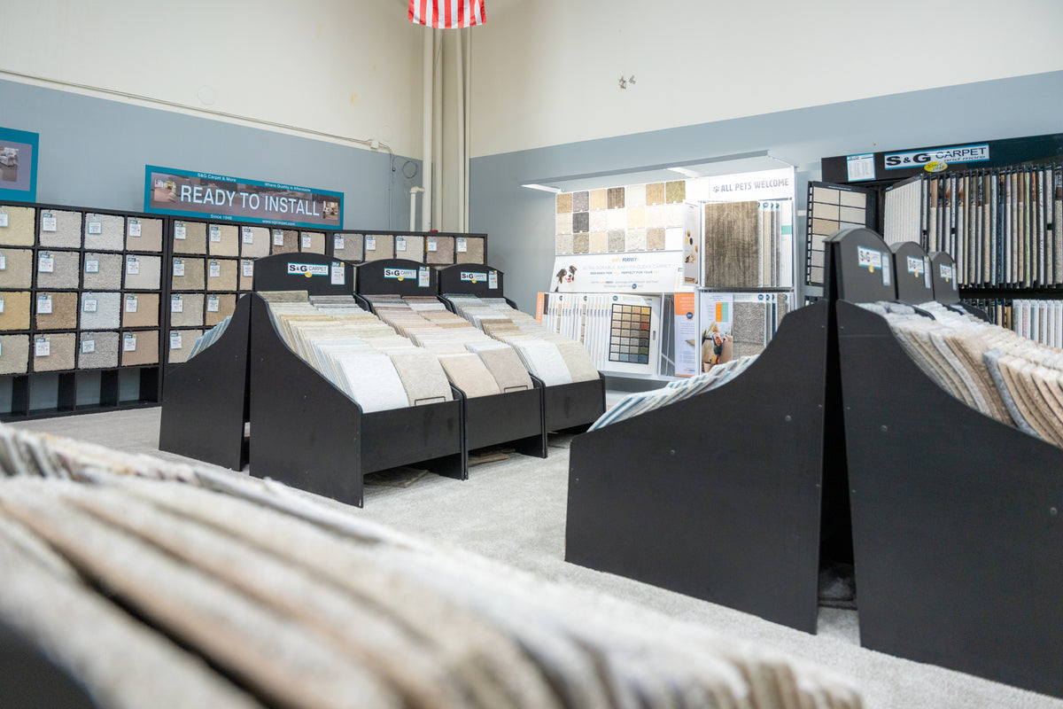 Carpet department at S&G Carpet with sample racks and a Ready to Install display wall