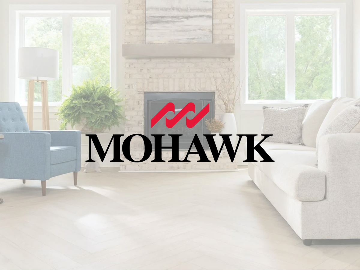 Mohawk logo over pale wood flooring in a bright living room with a fireplace