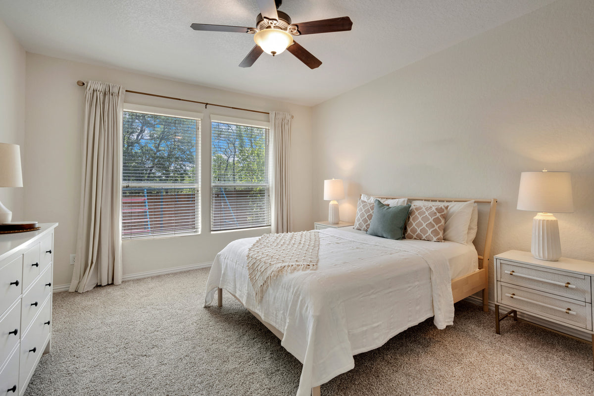 A bedroom features soft carpet flooring.