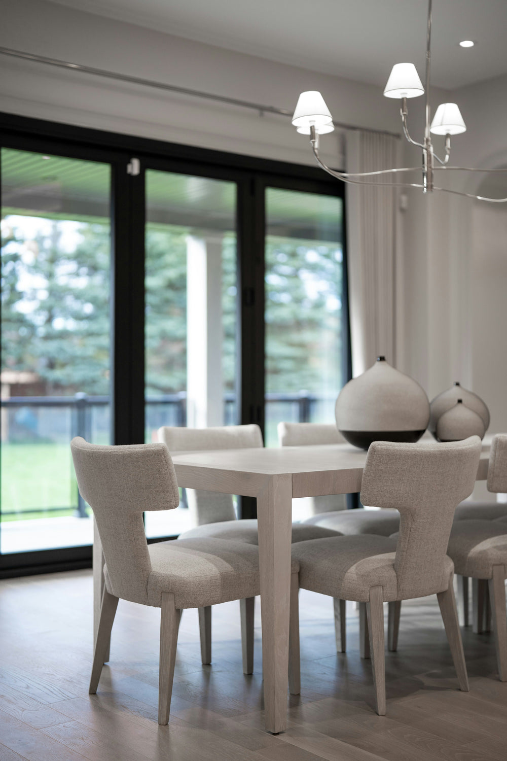 A dining area features warm wood flooring.