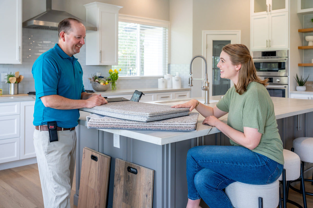 S&G Carpet and More employee provides carpet and hardwood consultation in home. 